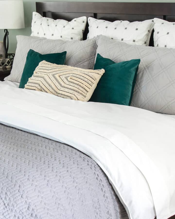 Closeup of king bed pillow arrangement and duvet cover.