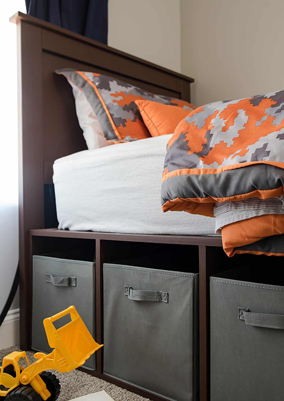 Close up of diy headboard and top portion of platform bed frame storage area.