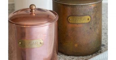 Two cannisters showing the before and after cleaning copper to remove tarnish.