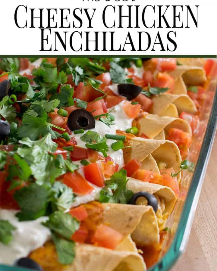 Cheesy chicken enchiladas in a glass dish with toppings.