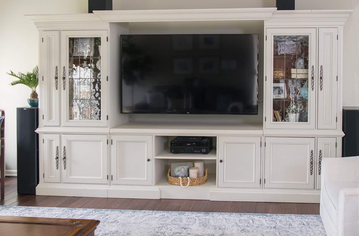 Large white painted entertainment center after DIY makeover and refinishing with Fusion Mineral.