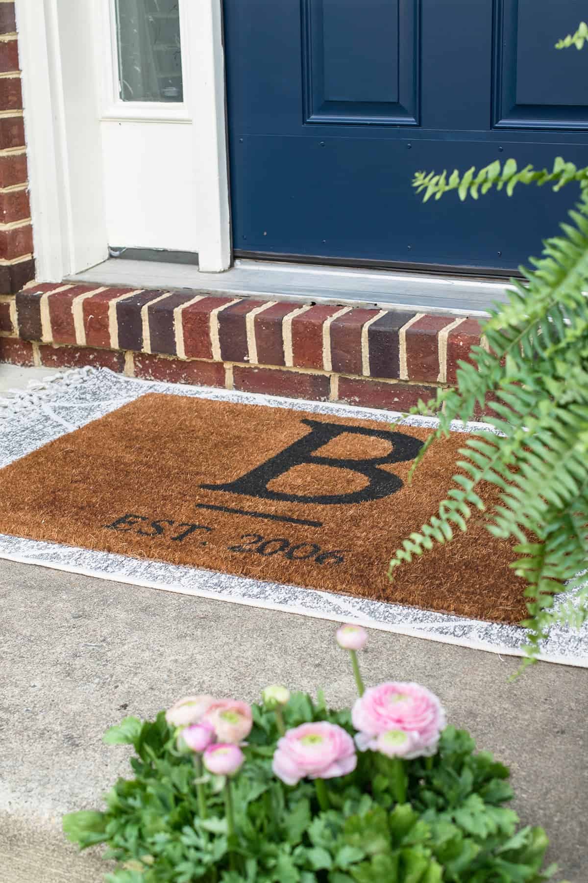 Layer outdoor rug under a doormat for instant chic according to style trends.