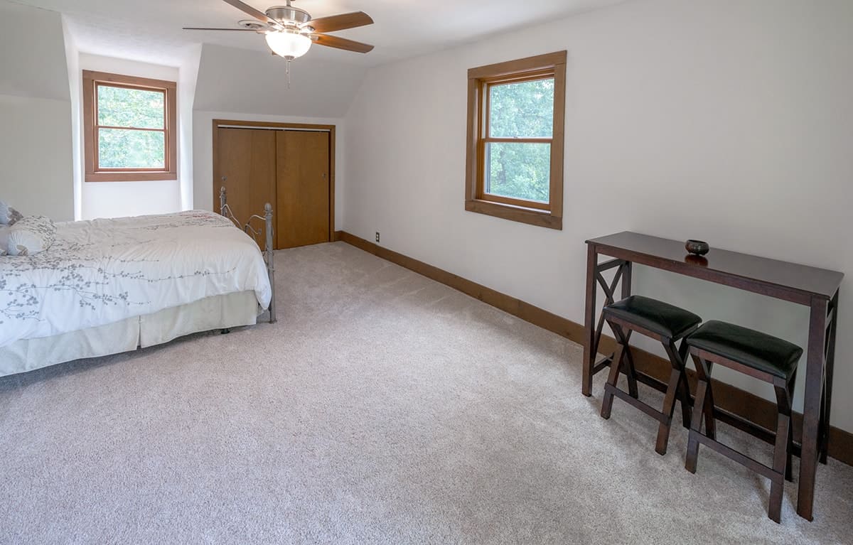 Neutral painted bedroom with wood floor boards.