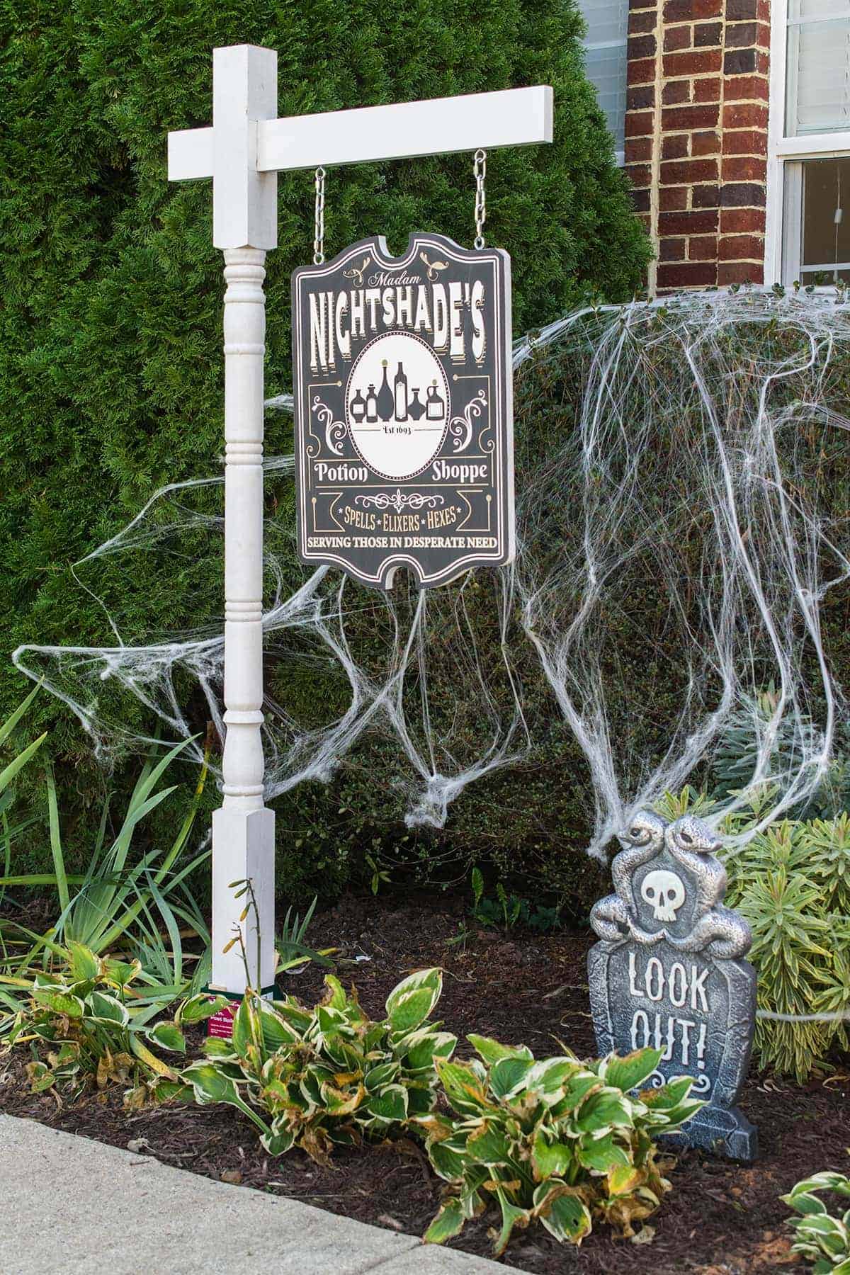 DIY Yard sign with post. The outdoor sign is a Potion Shoppe theme for Halloween.