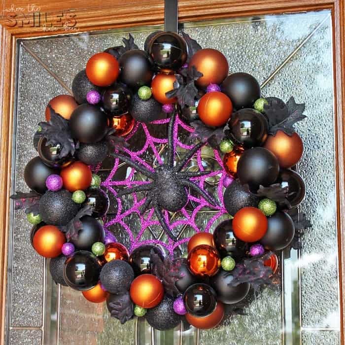 DIY colorful Halloween ornament wreath in purple, black, and orange wreath with spider and spider web.