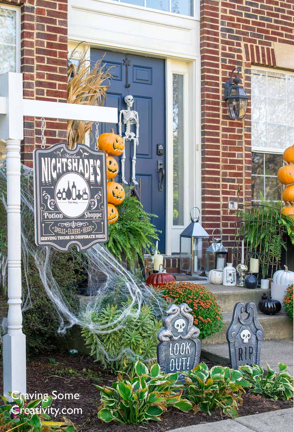 Halloween front porch decor. Pumpkin topiaries, DIY Potion Shoppe sign, DIY luminiaries, headstones, skeleton and black and white pumpkins.