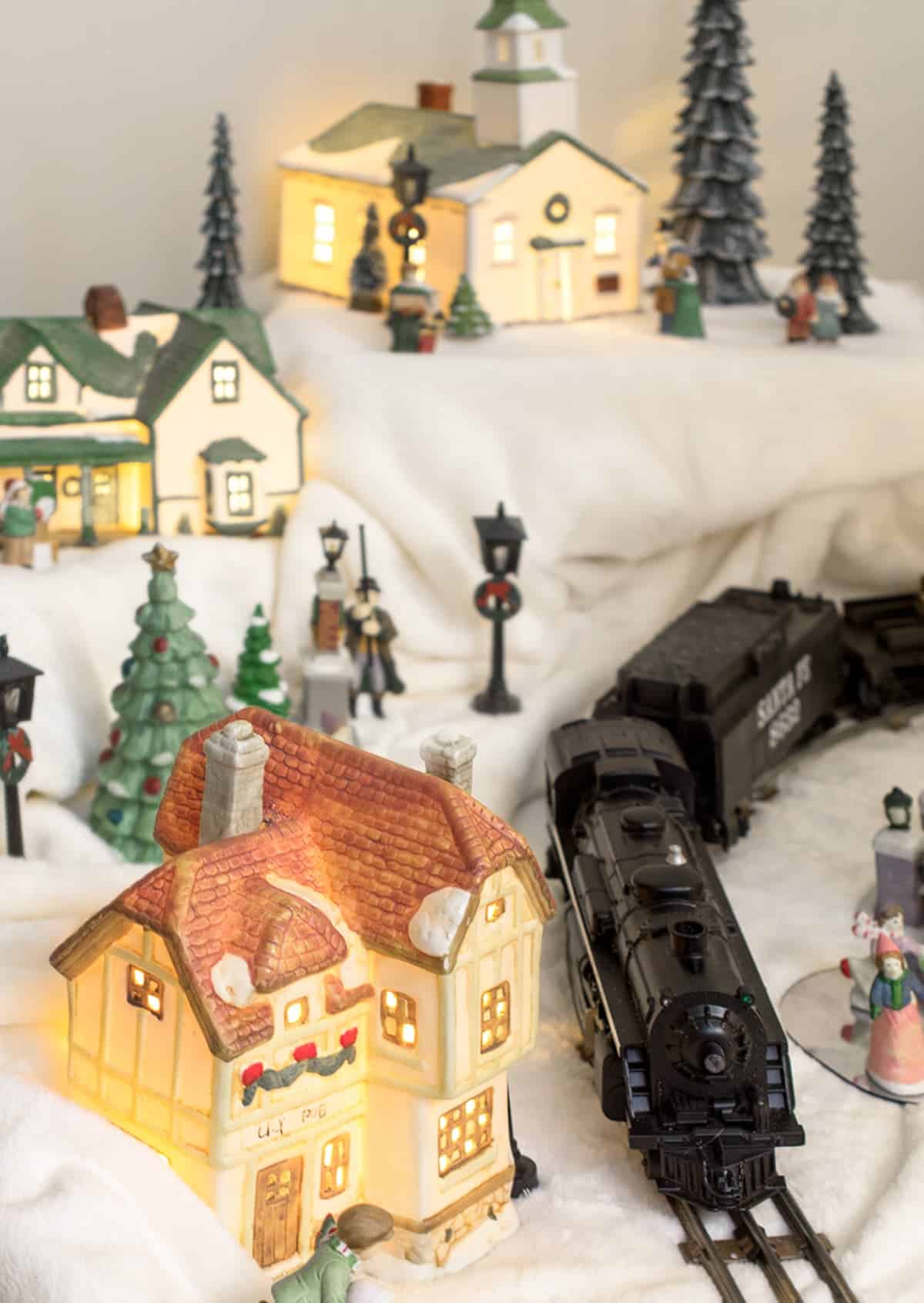 Antique Christmas Village Display complete with Lionel antique train under the Christmas Tree.