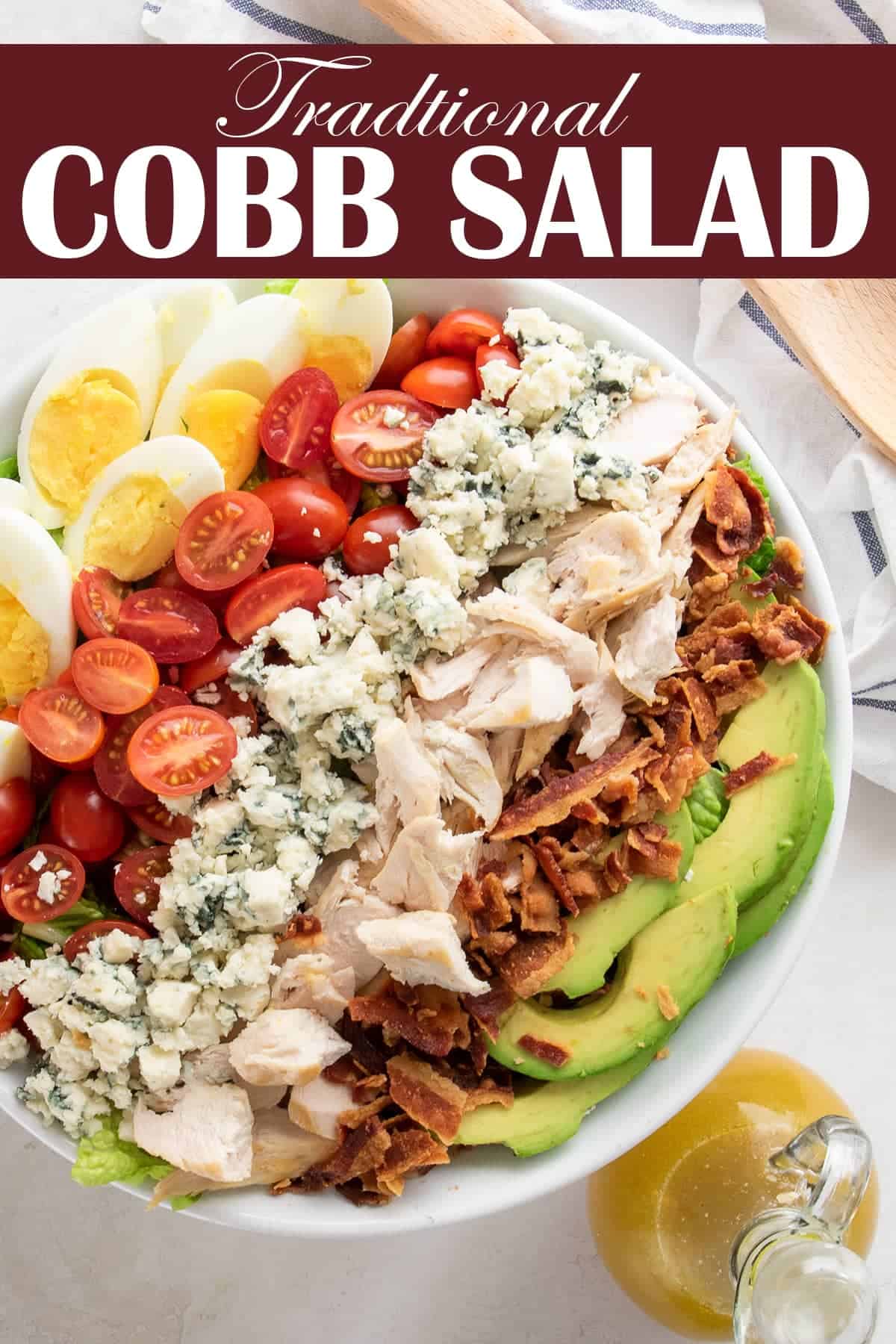 Colorful Cobb Salad with chopped ingredients carefully laid in a row in the bowl. 