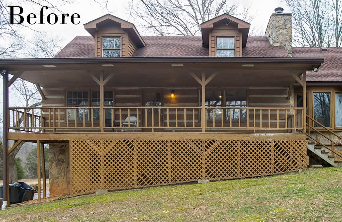 The front of a log cabin house with deteriorating deck and siding.