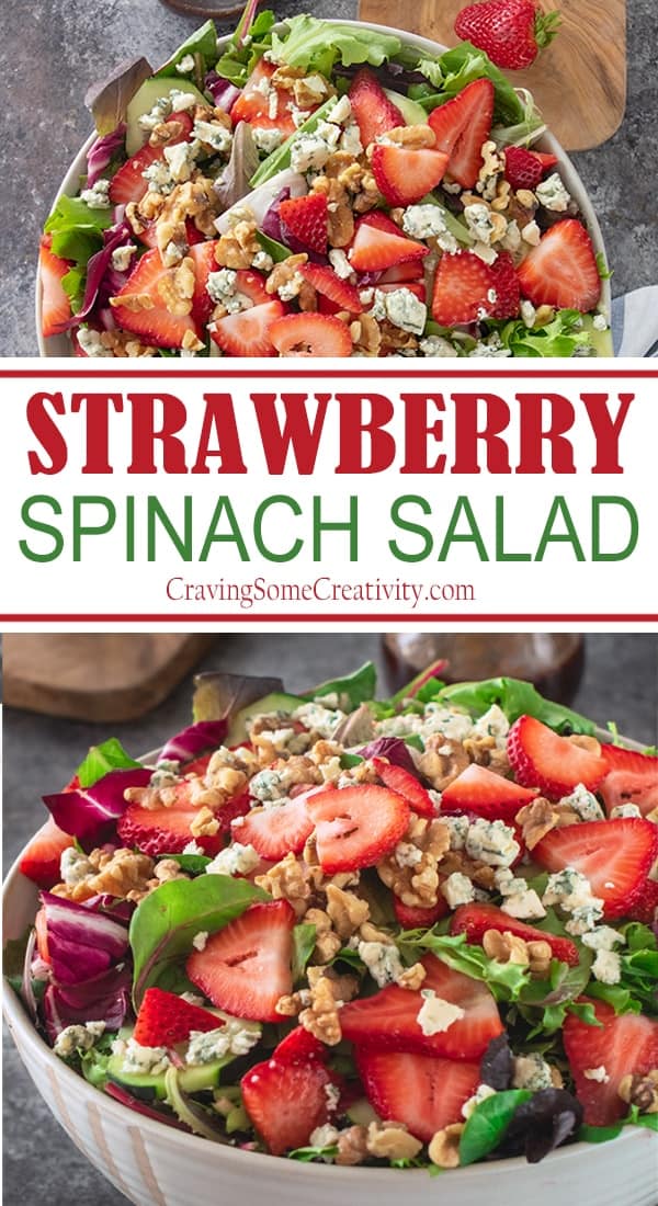 Strawberry spinach salad showed in a white bowl with blue cheese crumbles, chopped walnuts and spring greens.