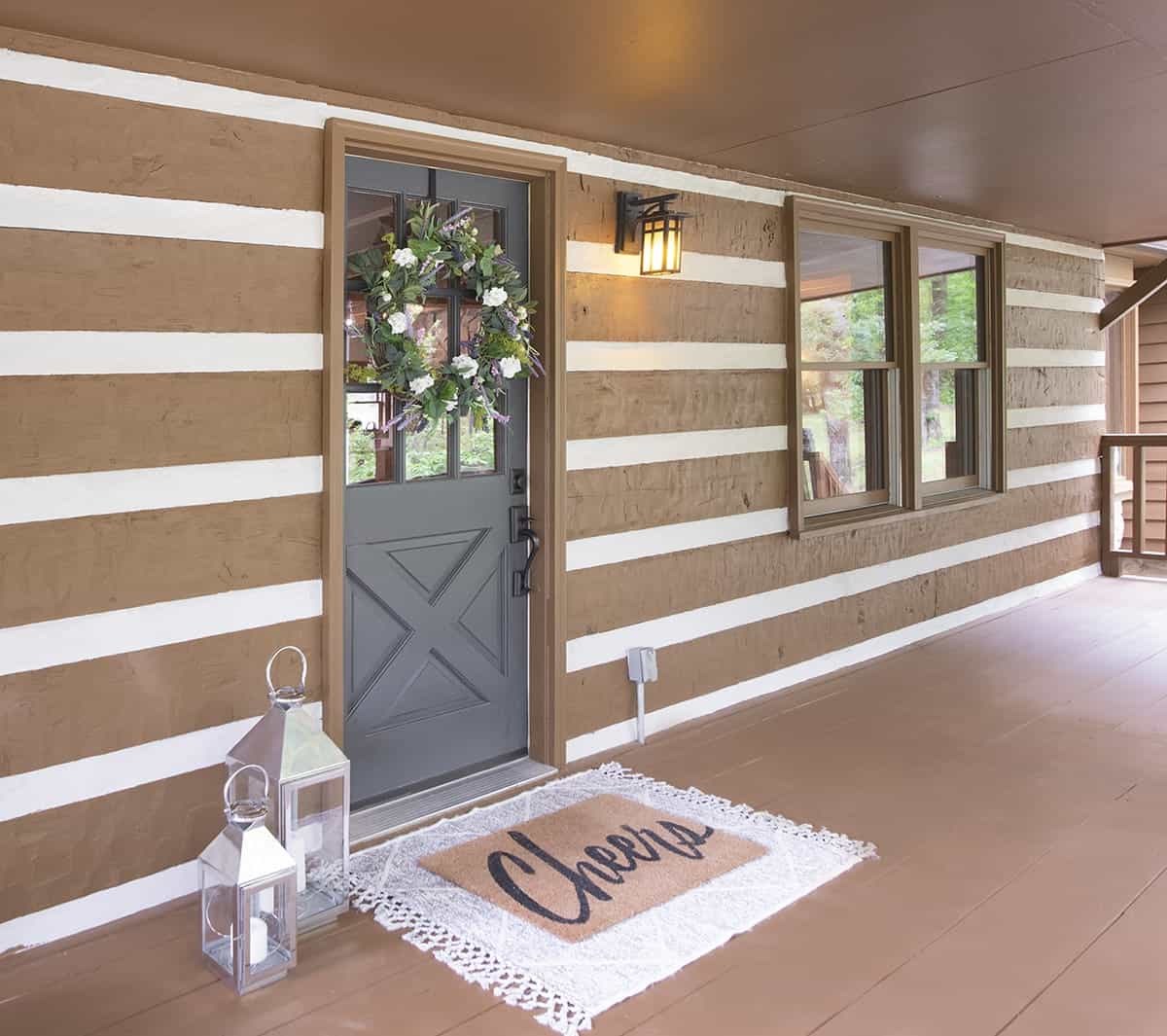 Refreshed exterior log cabin with painted cement fillers between the logs.