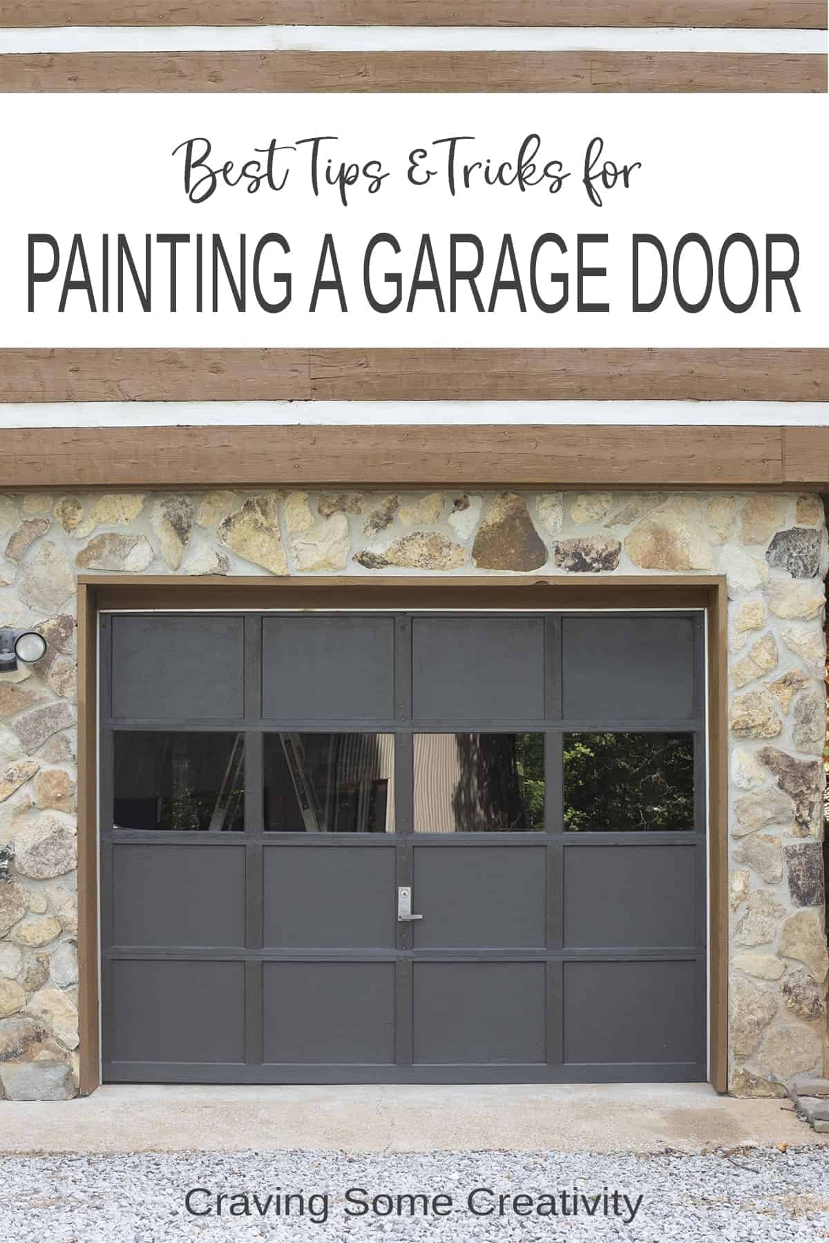 Painted grey garage door with stone facing around it.