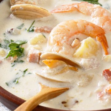 Close up of seafood chowder with mussels and shrimp.