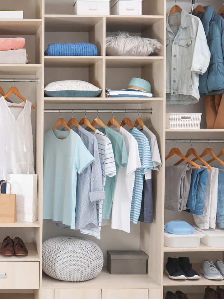 An organized closet with blue clothes and title that reads how to organize a room in one day.