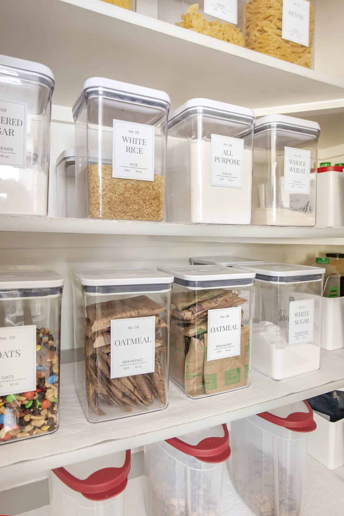 Clear labeled canisters keep staples like rice, flour and oatmeal orderly on pantry shelves. Clear plastic pour bins keep cereal fresh on the bottom shelf.