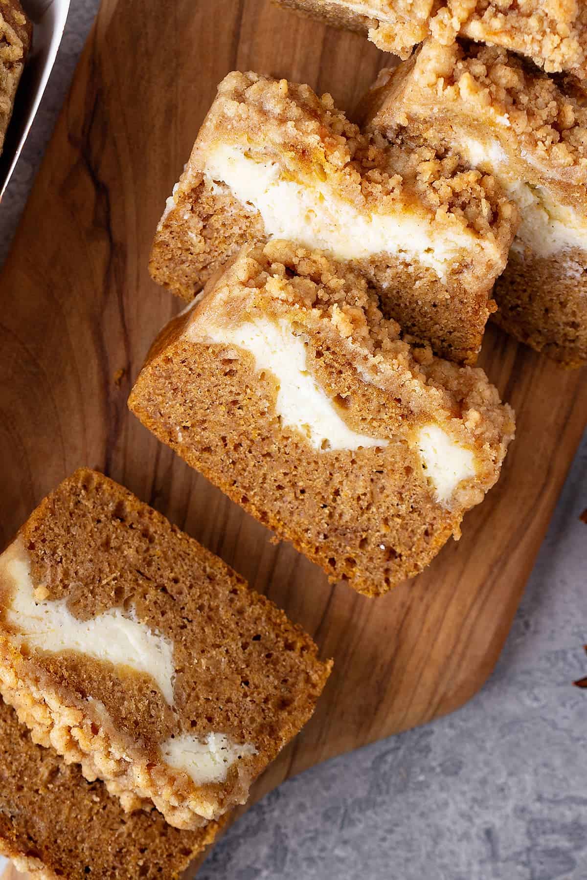 Pumpkin cream cheese swirl bread laid out on a table.