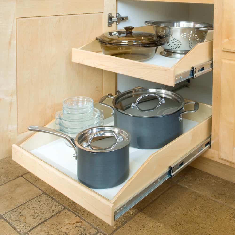 Sliding pull out shelves in kitchen cabinet to store pots, pans and other cookware.