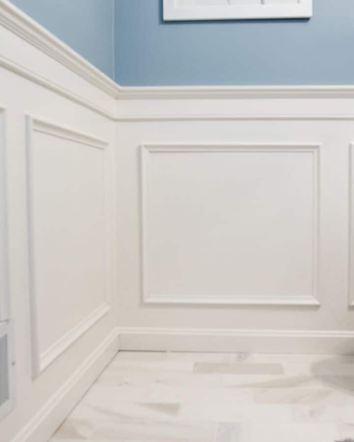 Traditional wainscoting on the wall with measurements to guide how to space trim.