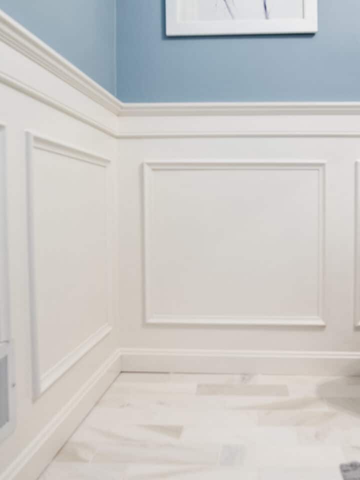 Traditional wainscoting on the wall with measurements to guide how to space trim.