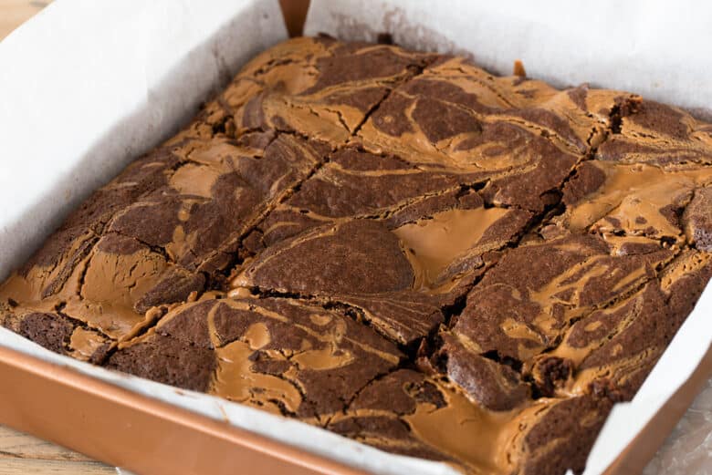 Freshly baked marbled brownies from the oven that are cut and ready for serving.