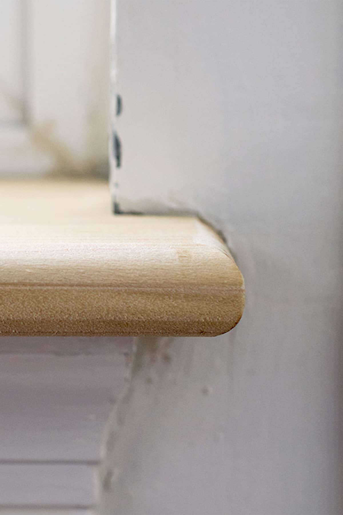 Top down view of a pet damaged wood window sill before repair.