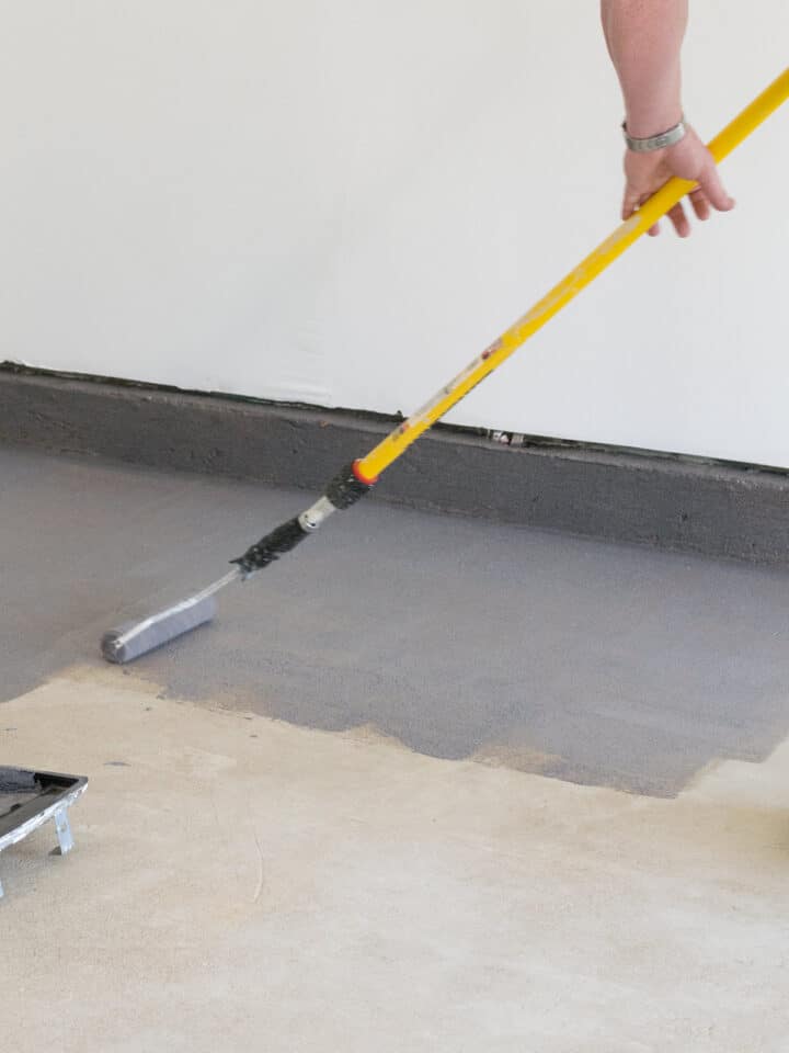 Garage with gray painted floor that is clean and organized.