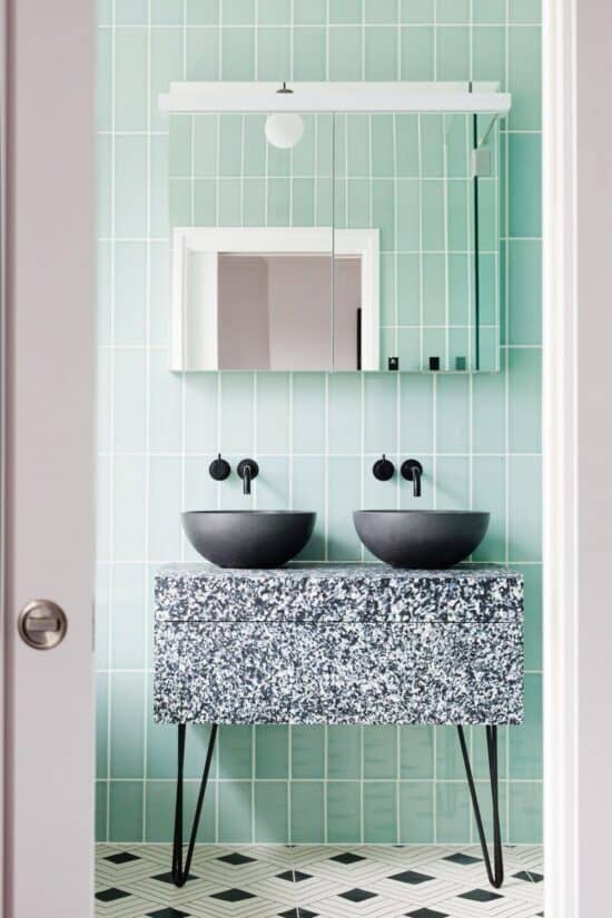 Mint pastel bathroom with subway tile wall.