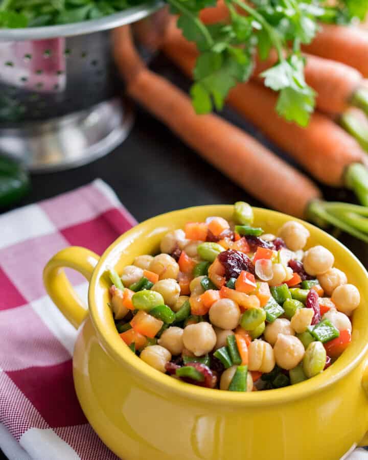 Delicious Summer Chickpea Salad consisting of delicious chopped salad with lots of veggies, cranberries, and a tangy vinaigrette dressing.