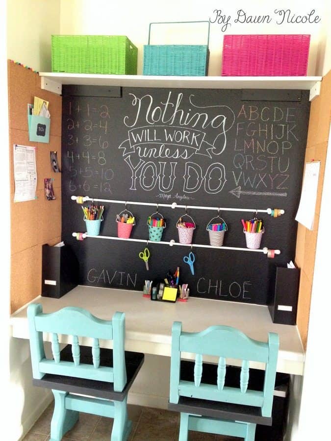 Homework station with colorful hanging buckets with coloring supplies with white desk against black background with inspirational quotes.