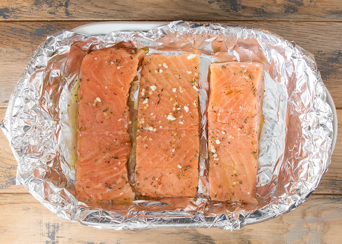 Three fillets of salmon in foil ready to bake.