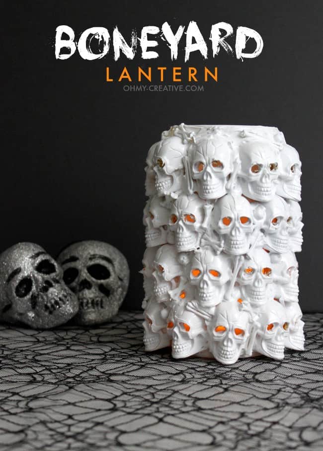 Large jar decorated with plastic skulls with title that reads boneyard lantern.