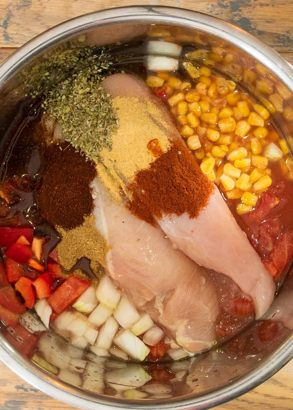 Overhead of soup ingredients put into a slow cooker before cooking.