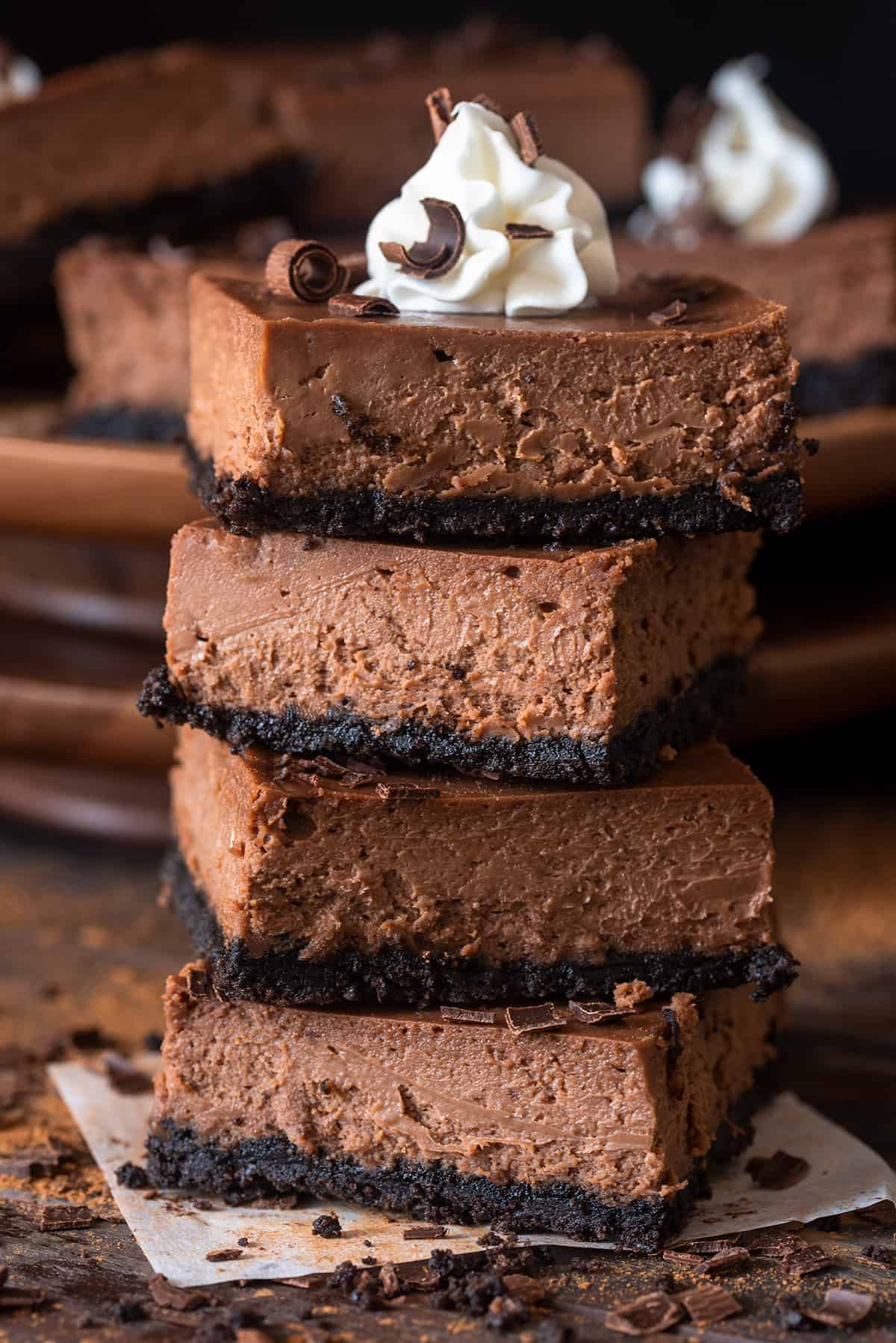 Chocolate Cheesecake Bars stacked four high.