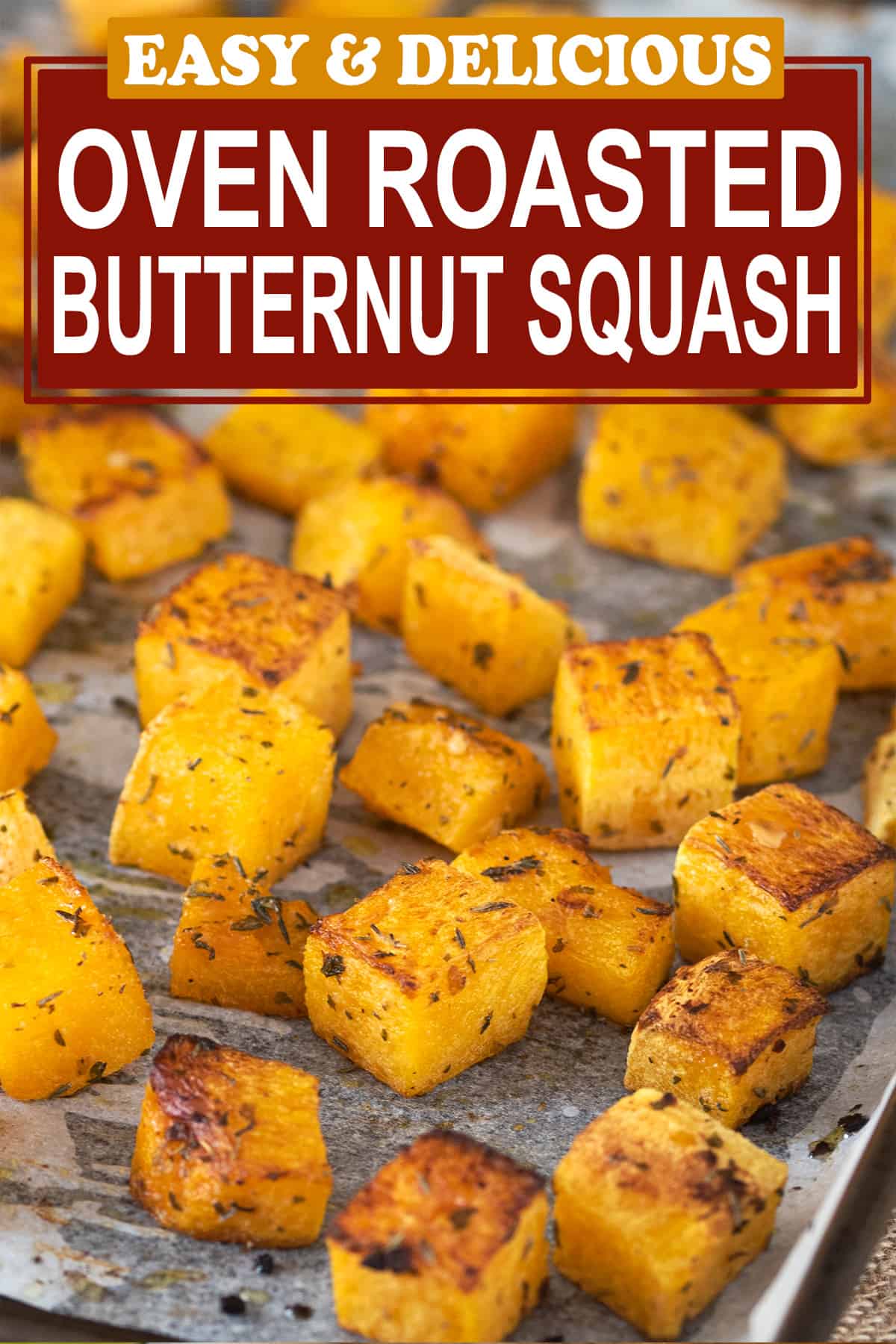 Baked butternut squash laid out on a sheet pan with sprinkled seasonings. Post title is on top.