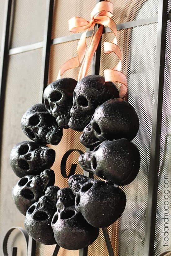 Black skull wreath hanging on door.