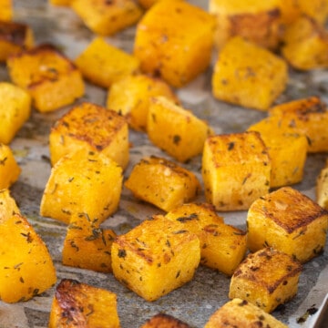 Roasted Butternut Squash in a sheet pan with parchment paper.