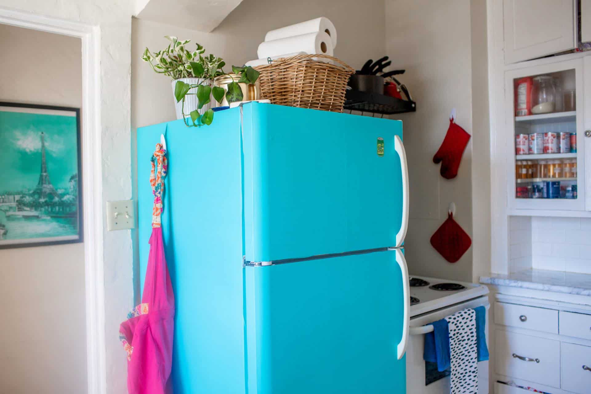 Bright blue painted refrigerator.