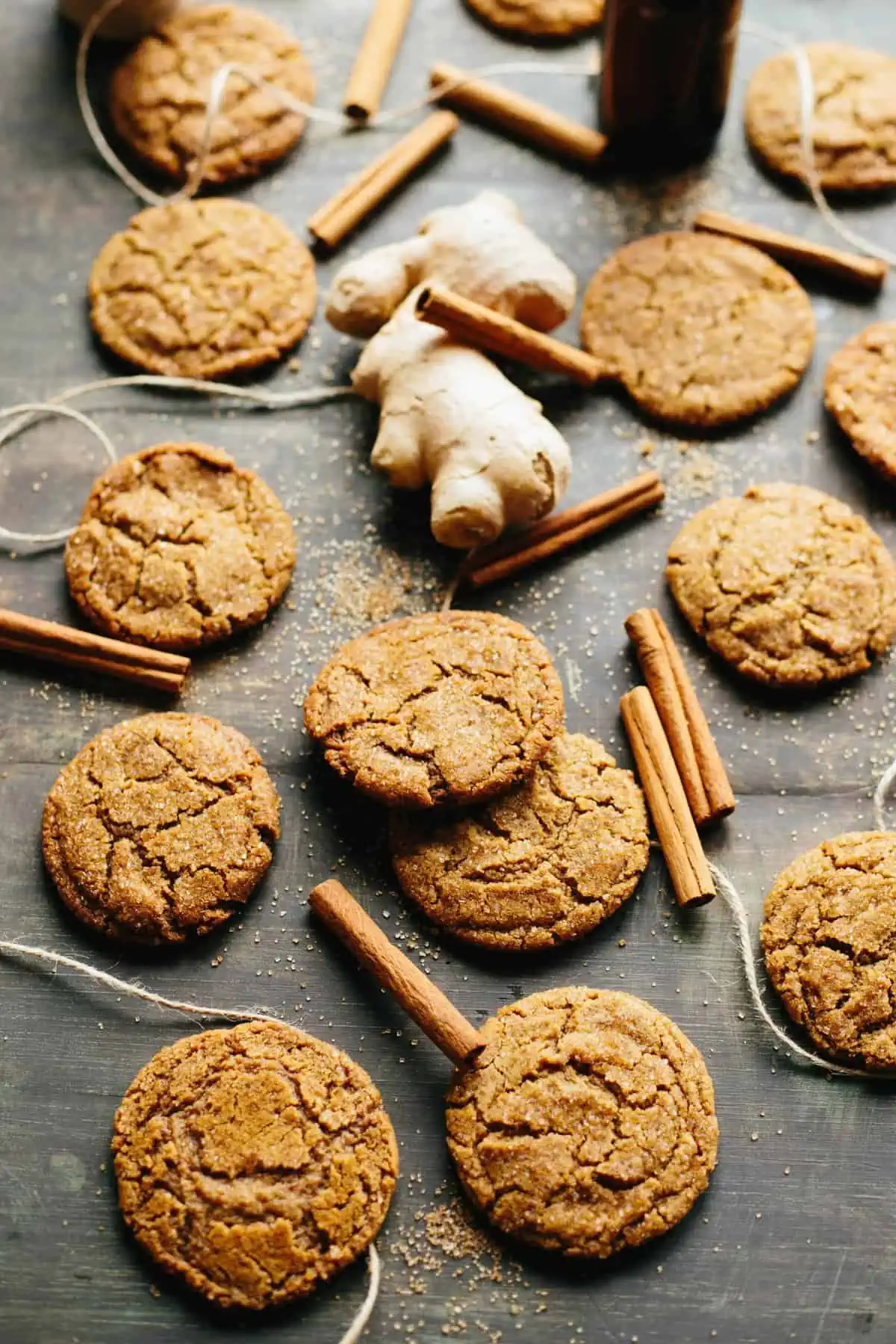 Several brown butter ginger molasses cookies spread out on a table.