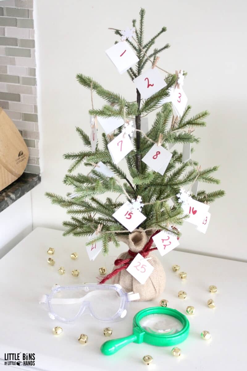 Small Christmas tree featuring an advent calendar made of garland with notes and snowflake clothespins.