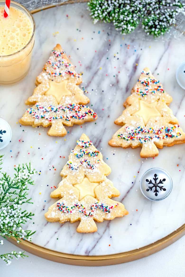 Christmas tree shaped linzer cookies with eggnog centers.