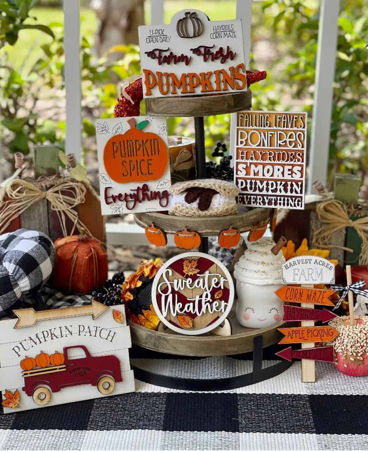 Fall decorated serving tray with sweaters, pumpkins, and mini-signs.