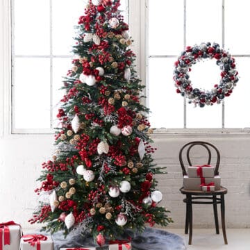 Nordic Christmas tree with red and white decorations and cozy lodge style.