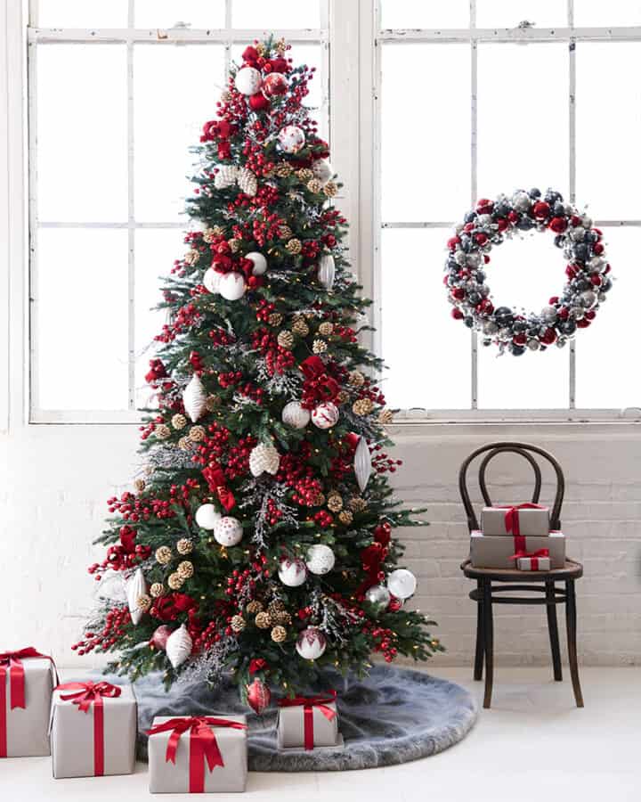Nordic Christmas tree with red and white decorations and cozy lodge style.