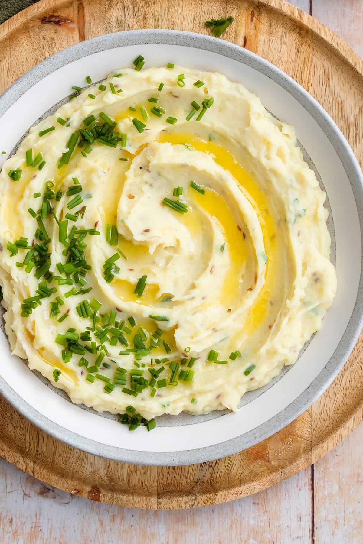 Creamy, buttery mashed potatoes with chives in a bowl.