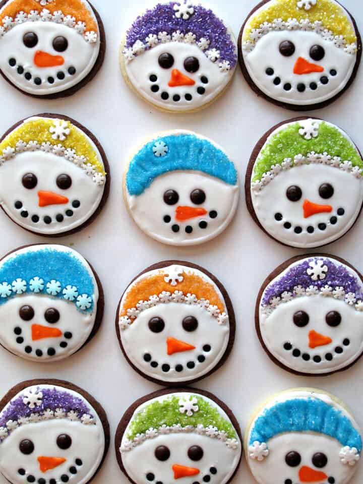 Iced sugar cookies with snowman faces.