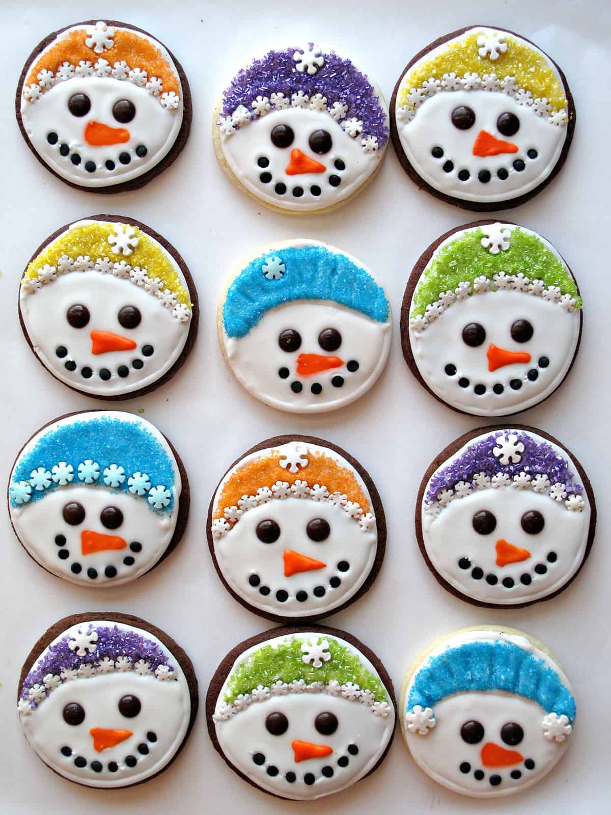 Iced sugar cookies with snowman faces.