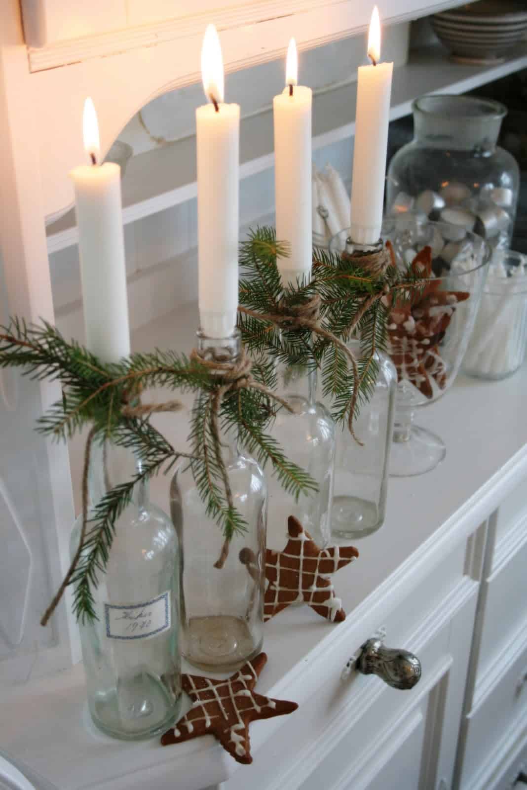 Candle centerpiece made from recycled wine bottles for cheap Christmas decoration.