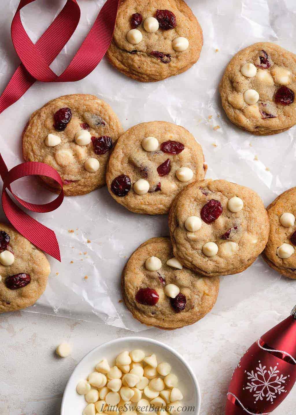 White chocolate cranberry cookies laid on wax paper.