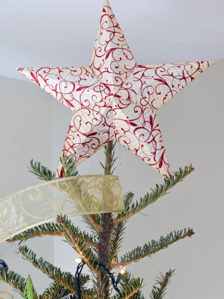 Paper 3-D star atop tree. Star is stamped red and white with glitter.
