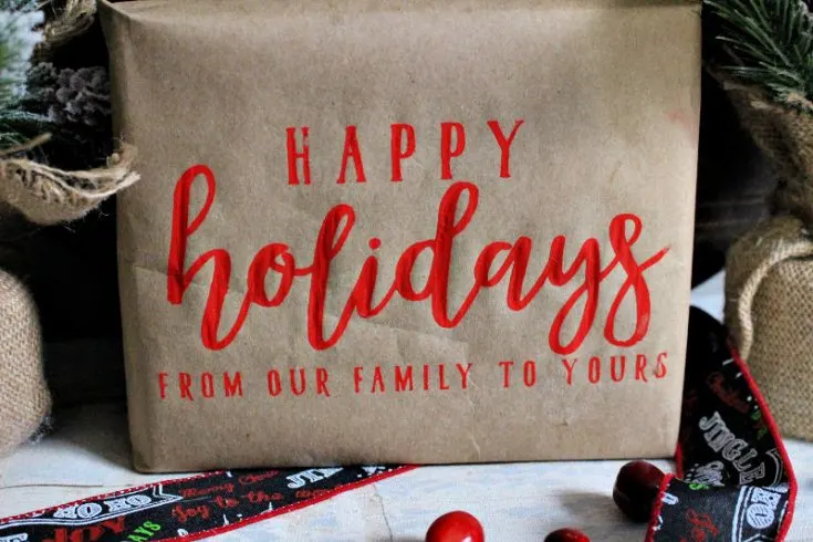 Brown paper package with red Happy Holidays chalk stamp decoration